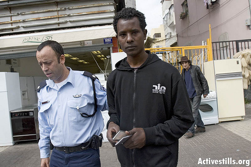 Immigration police arresting an Eritrean refugee, Tel Aviv, Israel, 2/3/2008. by activestills.